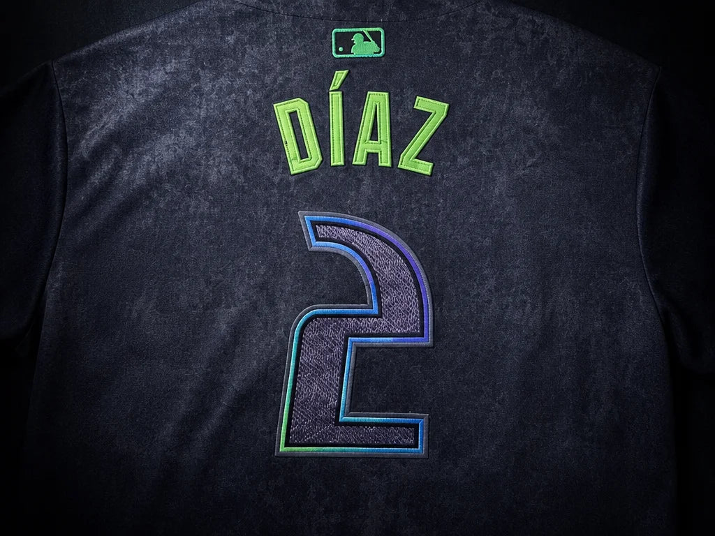 Close-up of the stitched DIAZ nameplate and number 2 on the dark Tampa Bay Rays jersey